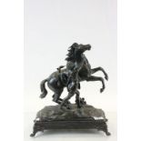 Spelter model of rearing horse with native African figure, marked Coustou to base