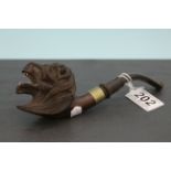 A vintage pipe with carved lion head bowl.