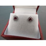 A pair of 18ct W/G ruby and diamond earrings of 60 points