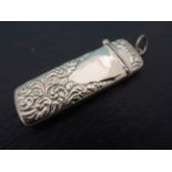 A silver embossed needle case with hinged lid