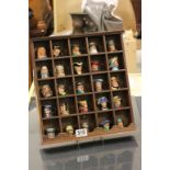 A collection of twenty five miniature character jugs including Sherlock Holmes, Dr Watson, Alice