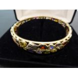 A good 14ct Y/G bangle set with many gemstones to include citrine, peridot amethyst, garnet,