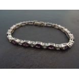 A silver amethyst and CZ line bracelet