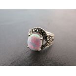 A silver Marcasite and large central opal ring in the Art Deco style