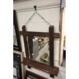 A vintage oak mirror with bevelled glass