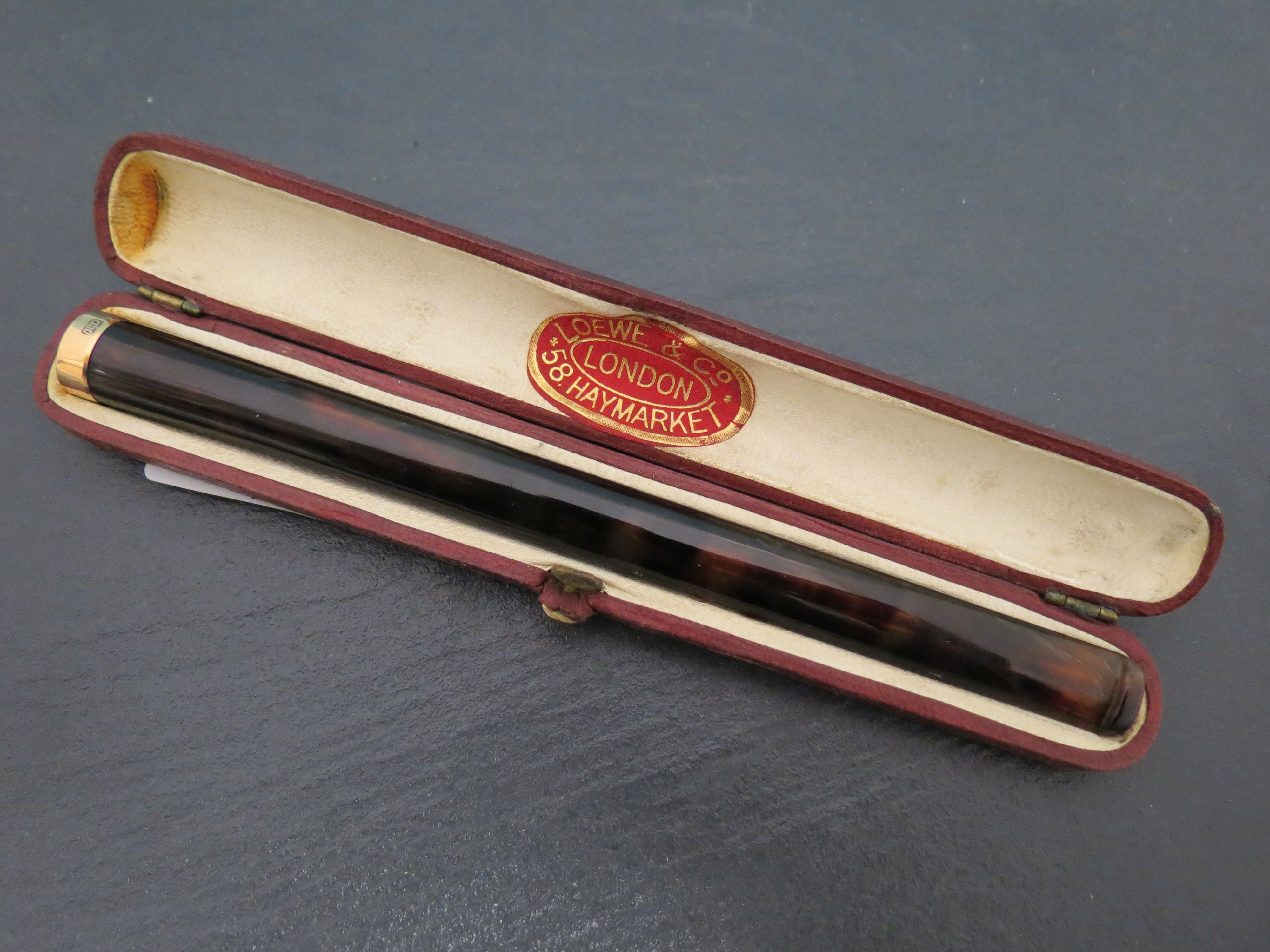 Cased Loewe and co tortoise shell cheroot holder with gold end cap