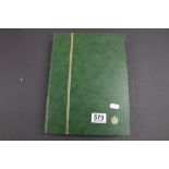 Green stock book with a quantity of world used stamps