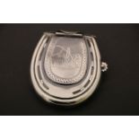 A silver plated vesta case in the form of a horseshoe