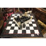 A contemporary chess set of medieval characters and marble board.