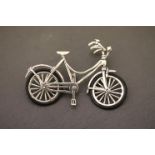An unusual silver model of a ladies bicycle with rubber tyres