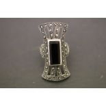 A large silver marcasite Art Deco style ring with central onyx panel