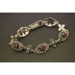 A silver marcasite and ruby paneled bracelet