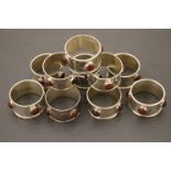 Set of Ten Arts and Crafts Style Silver Plated Napkin Rings each set with four cabouchon glass