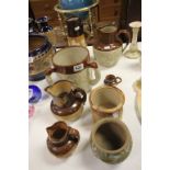 Collection of eight Harvest ware style jugs etc to include Doulton Lambeth and a large Tyg