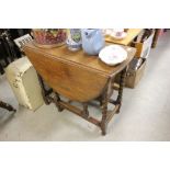 Oak Gate-leg Table with Oval Flaps raised on barley-twist legs