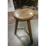An vintage three legged stool