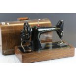 Vintage Singer sewing machine with wooden cover
