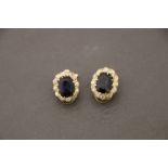 A pair of yellow gold sapphire and diamond cluster earrings