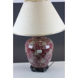 A vintage oriental purple ground ovoid lamp with shade.