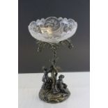 A cut glass bowl on a cast metal stand depicting two figures grape picking