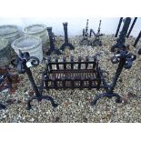 Pair of Iron Fire Dogs with Scroll Finials and Twisted Supports together with a Fire Grate