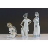 Three Nao Figurines to include a girl with puppy, child with a large toy & number 1110