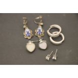 Four pairs of silver earrings