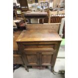 Early 20th century Oak Cabinet, the top with lift lid and drop down flap over two cupboard doors