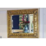 Ornate gilt framed wall mirror with bevelled glass