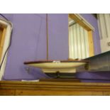 Good quality vintage wooden pond yacht with painted hull and weighted keel,on wooden plinth. 26"