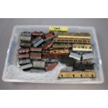 Collection of 35 OO gauge kit built rolling stock items and one engine contained in two plastic