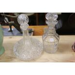 A cut glass ships decanter and a three ring stemmed decanter.