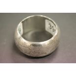 Heavy bangle with hand punched decoration and hallmarked "Silver"