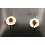 A pair of 18ct yellow gold ruby and diamond cluster earrings