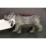 A vintage pin cushion in the form of a Rhino with glass eyes.