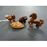 Four miniature netsukes to include a dog, horse, dog of foe and fish