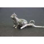 A heavy cast silver cat figure with emerald eyes