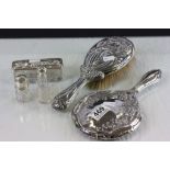 A silver dressing table set to include brush ,mirrors , scent bottles etc.