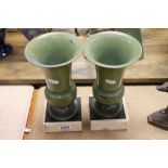 Pair of early 20th Century painted metal vase raised on marble plinths