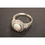 A silver CZ and opal dress ring