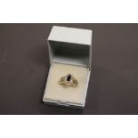 A substantial yellow gold sapphire and diamond ring