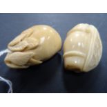 Two tagua nut carvings of fruit