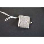 A silver pendant locket photo album