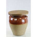 Large Stoneware Crock Pot with Thick Wooden Lid making it suitable as a stool