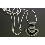 A silver and onyx Art Deco style pendant necklace on a silver chain