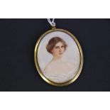 An early 20th century miniature portrait of a young lady signed with initials AN and dated 1914.