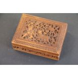 A profusely carved trinket box the lid carved with figure hunting tiger.