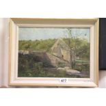 An early 20th century oil on board rural riverscene with cottage and stone bridge unsigned.