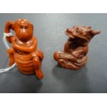 Two wood netsukes of a monkey bathing in tub and Chinese dragon with ball