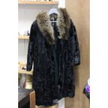 A black fur coat with fur collar.